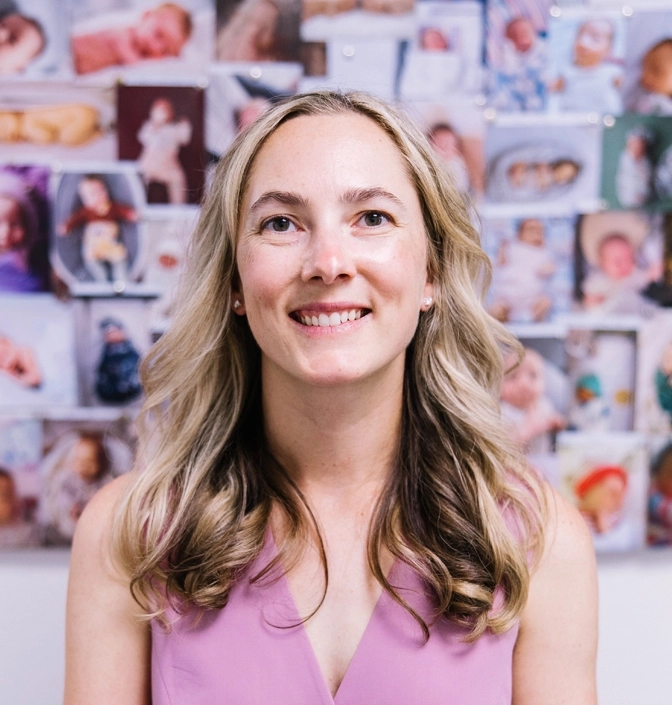 Dr Kate Burston, Newcastle fertility specialist with baby success stories wall