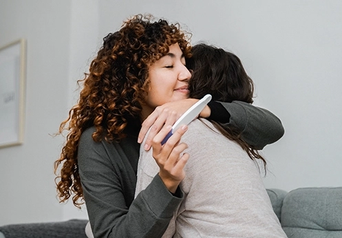 Mother and child celebrating positive pregnancy result – donor eggs and surrogacy options Newcastle, Dr Kate Burston