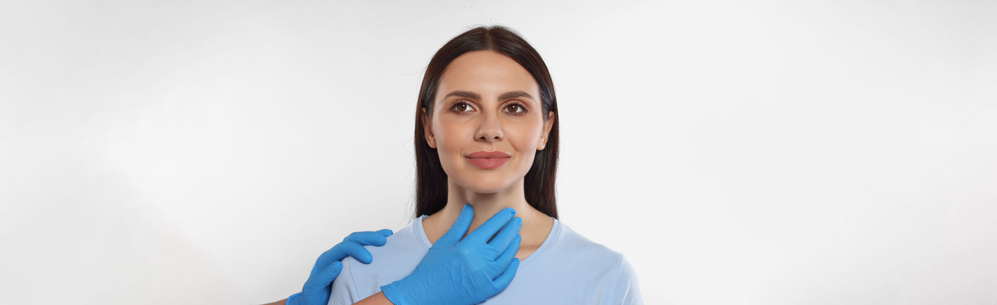 Doctor performing thyroid examination for reproductive endocrinology, Newcastle clinic