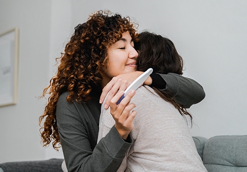 Mother and child celebrating positive pregnancy result – donor eggs and surrogacy options Newcastle, Dr Kate Burston